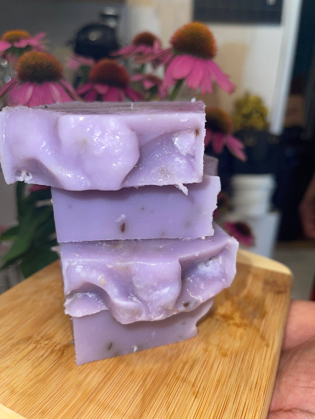 Noureture By Nature’s Lavender Infusion Handmade Soap. Handmade Vegan Soap. Organic Ingredients Soap. All-Natural Handmade Soap. Cruelty Free Ingredients Soap. Small Business Soap. Black Women in Business Soap. Handmade Soap on circular wooden board, placed on top of kitchen counter. Nigerian Shea Butter Handmade Soap.