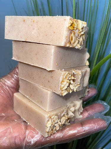 Noureture By Nature’s Oats, Honey, and Shea Butter handmade Soap. Handmade Vegan Soap. Organic Ingredients Soap. All-Natural Handmade Soap. Cruelty Free Ingredients Soap. Small Business Soap. Black Women in Business Soap. Female Holding Soap in hand next to blue back drop on a bright summer day. Nigerian Shea Butter Handmade Soap.